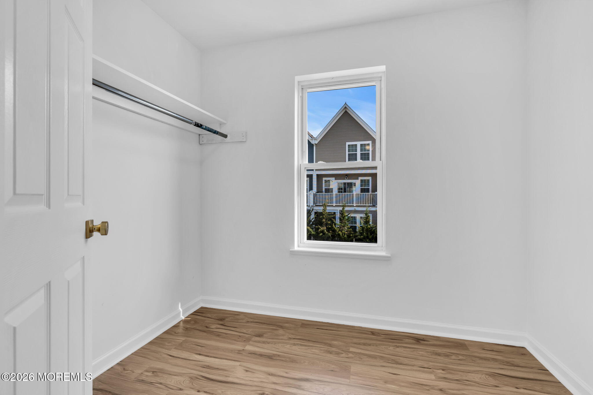 13 Locust Street Highlands, NJ 07732 - Photo 16 of 42 a view of an empty room with wooden floor and a window