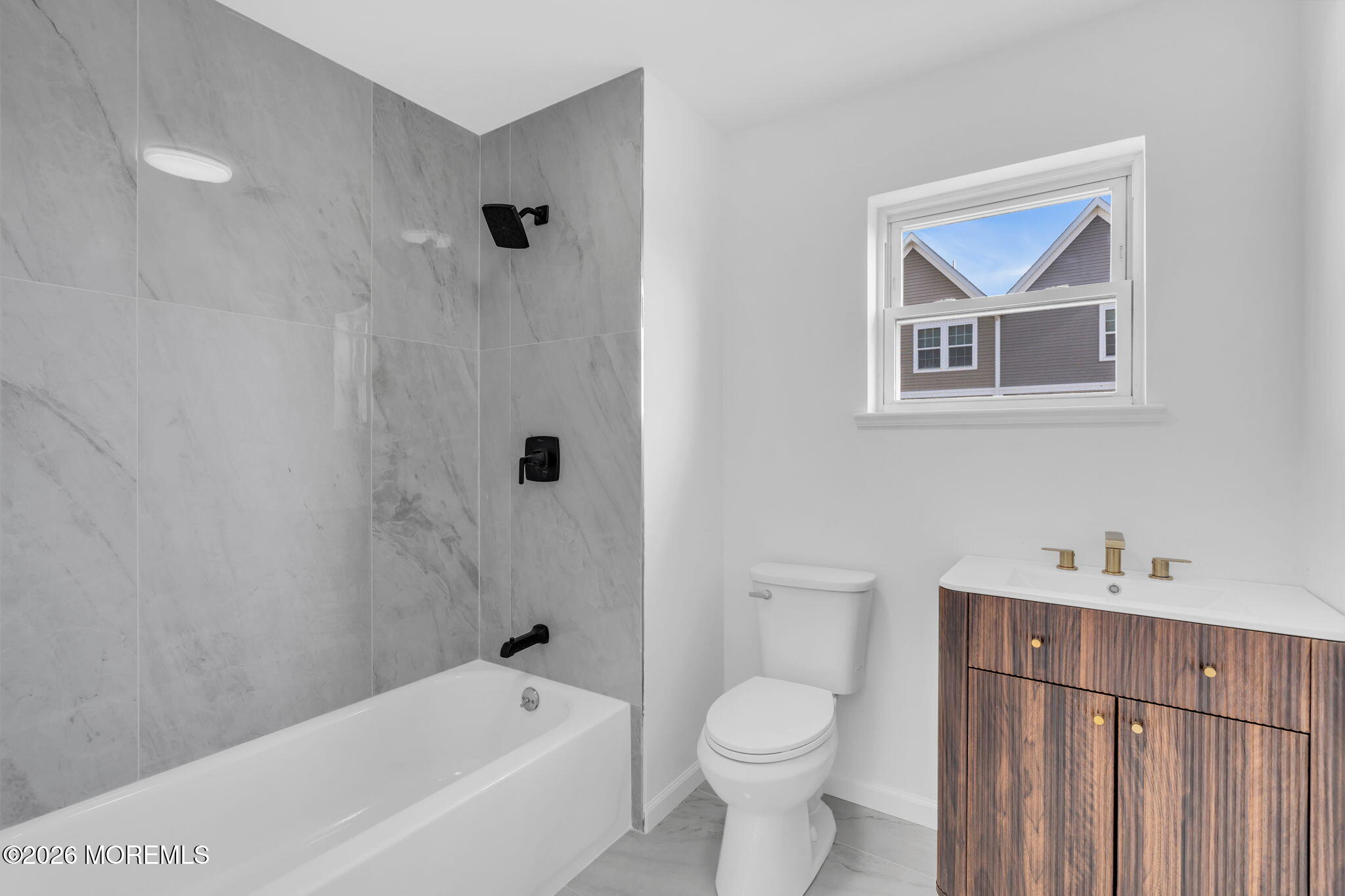 13 Locust Street Highlands, NJ 07732 - Photo 19 of 42 a bathroom with a toilet a sink a mirror and bathtub