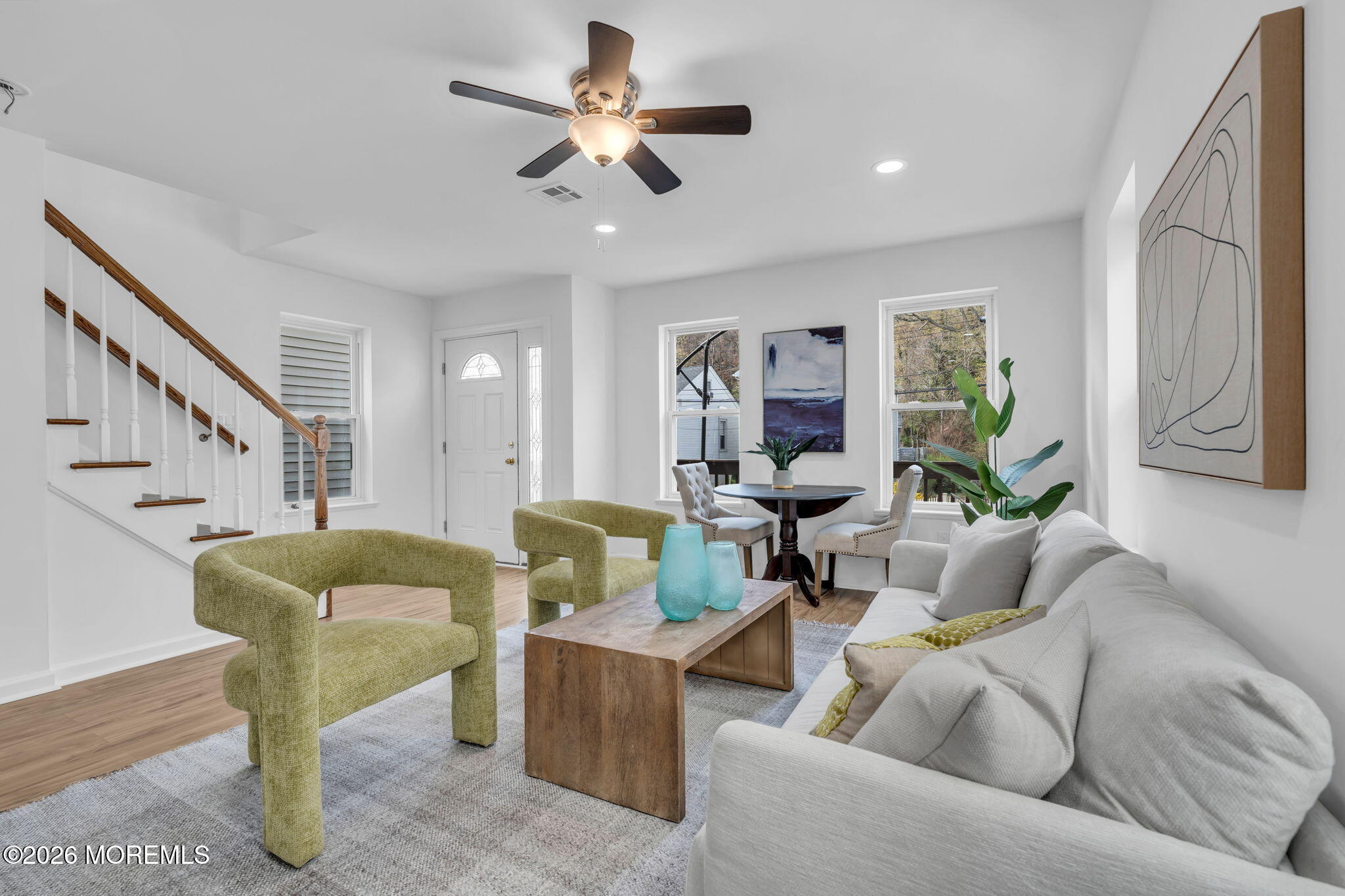 13 Locust Street Highlands, NJ 07732 - Photo 5 of 42 a living room with furniture and a chandelier