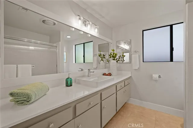 a bedroom with a large bed and a ceiling fan