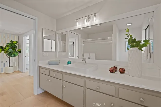 a bedroom with a bed and painting on the wall