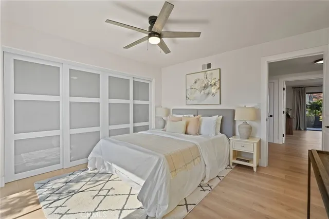 a bedroom with a bed and a large window