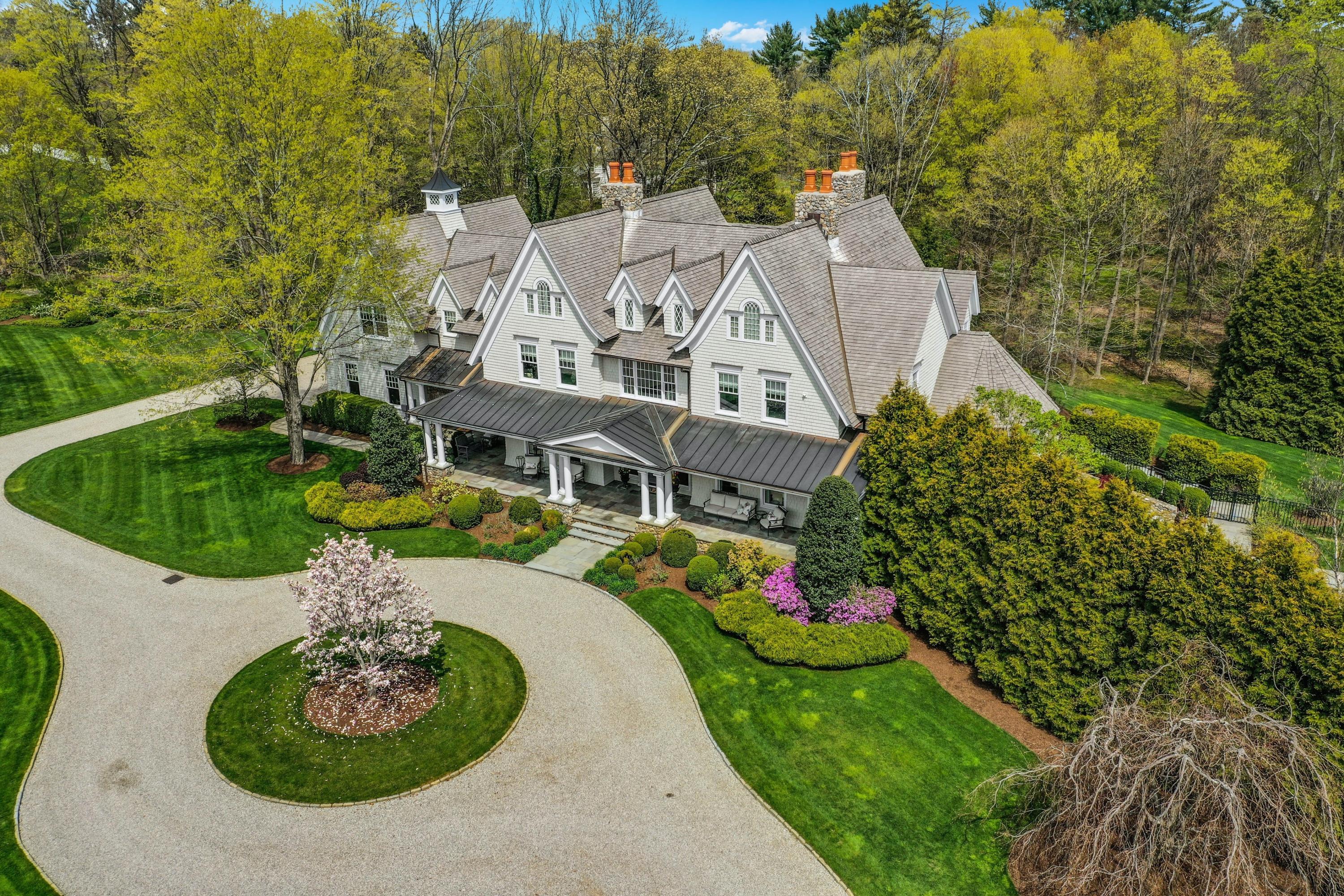 1083 Smith Ridge Road New Canaan, CT 06840 - Photo 1 of 39 an aerial view of a house with a garden