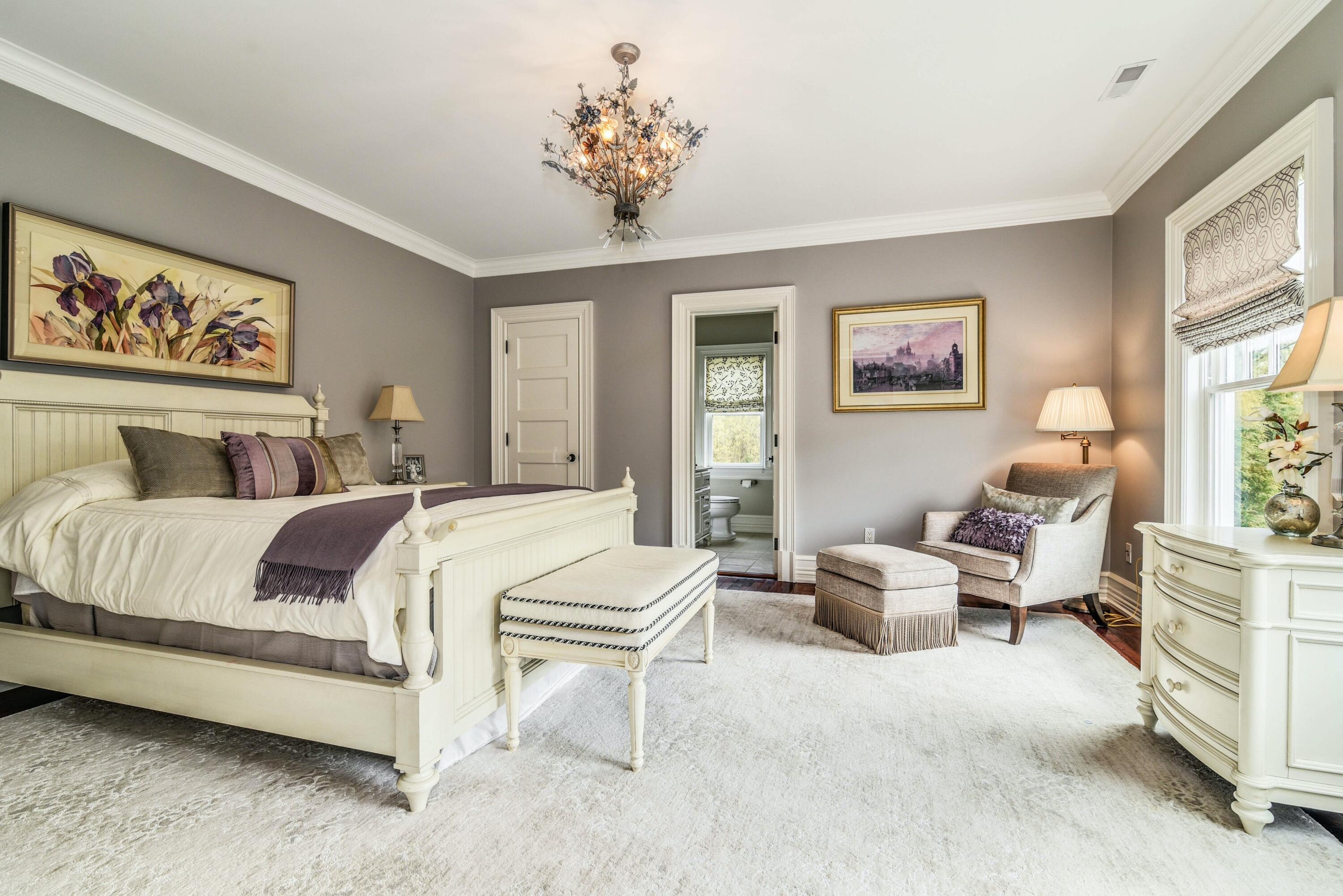 1083 Smith Ridge Road New Canaan, CT 06840 - Photo 14 of 39 a bedroom with a bed and a chandelier