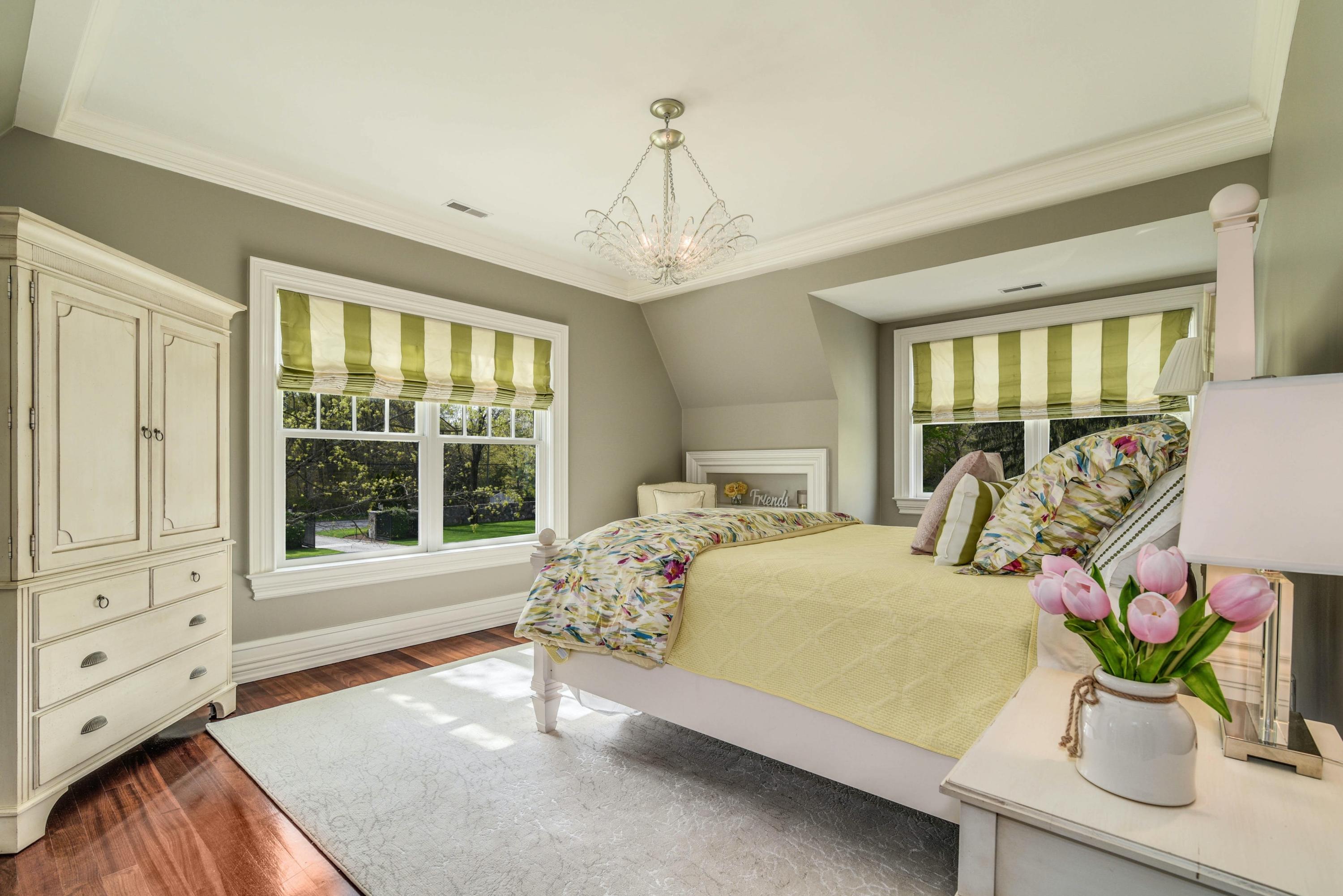 1083 Smith Ridge Road New Canaan, CT 06840 - Photo 23 of 39 a bedroom with a bed and large windows