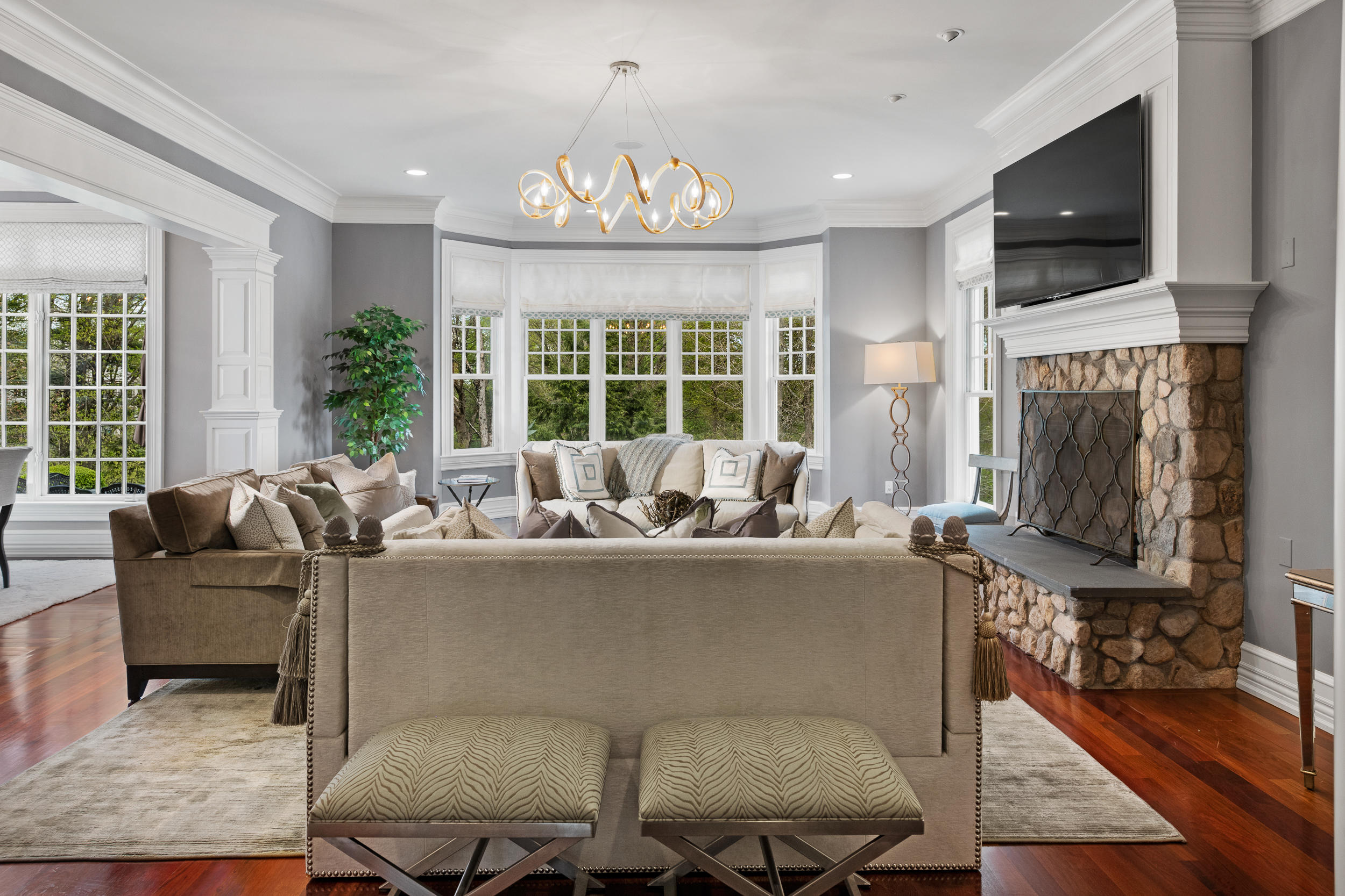 1083 Smith Ridge Road New Canaan, CT 06840 - Photo 6 of 39 a living room with furniture a fireplace and a flat screen tv