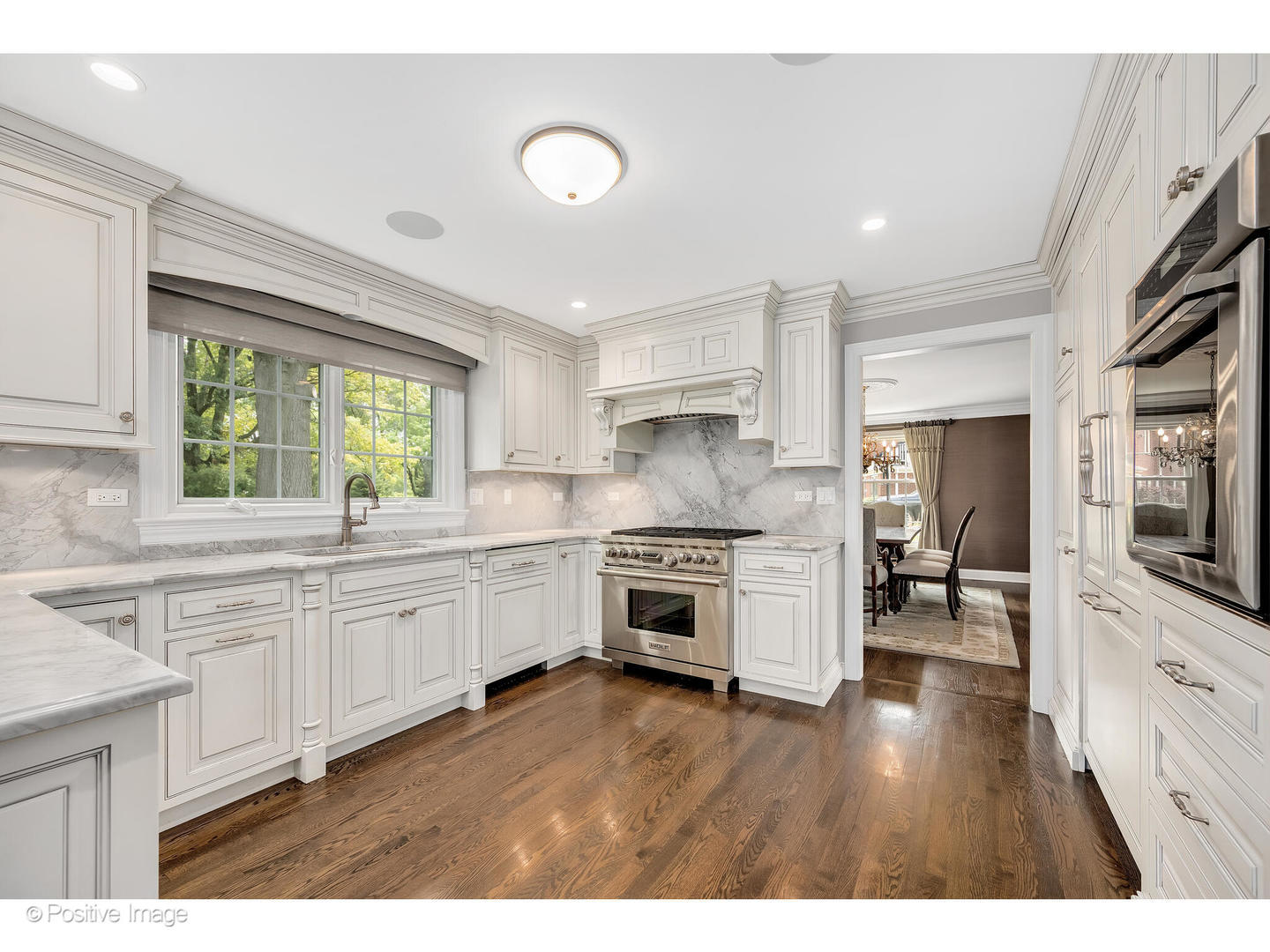 48 Devonshire Drive Oak Brook, IL 60523 - Photo 17 of 59 a kitchen with granite countertop white cabinets and white appliances