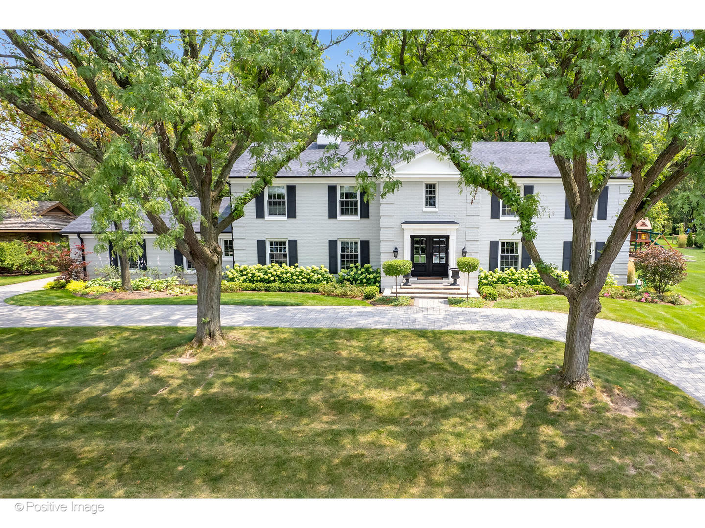 48 Devonshire Drive Oak Brook, IL 60523 - Photo 2 of 59 a front view of a house with a yard