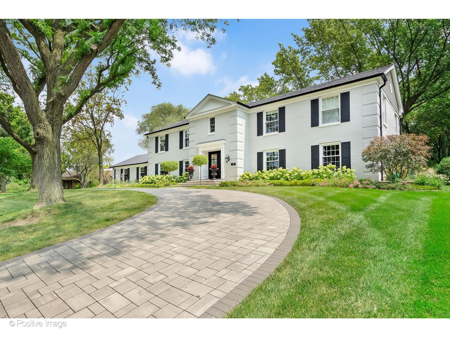 48 Devonshire Drive Oak Brook, IL 60523 - Photo 3 of 59 a front view of a house with a yard