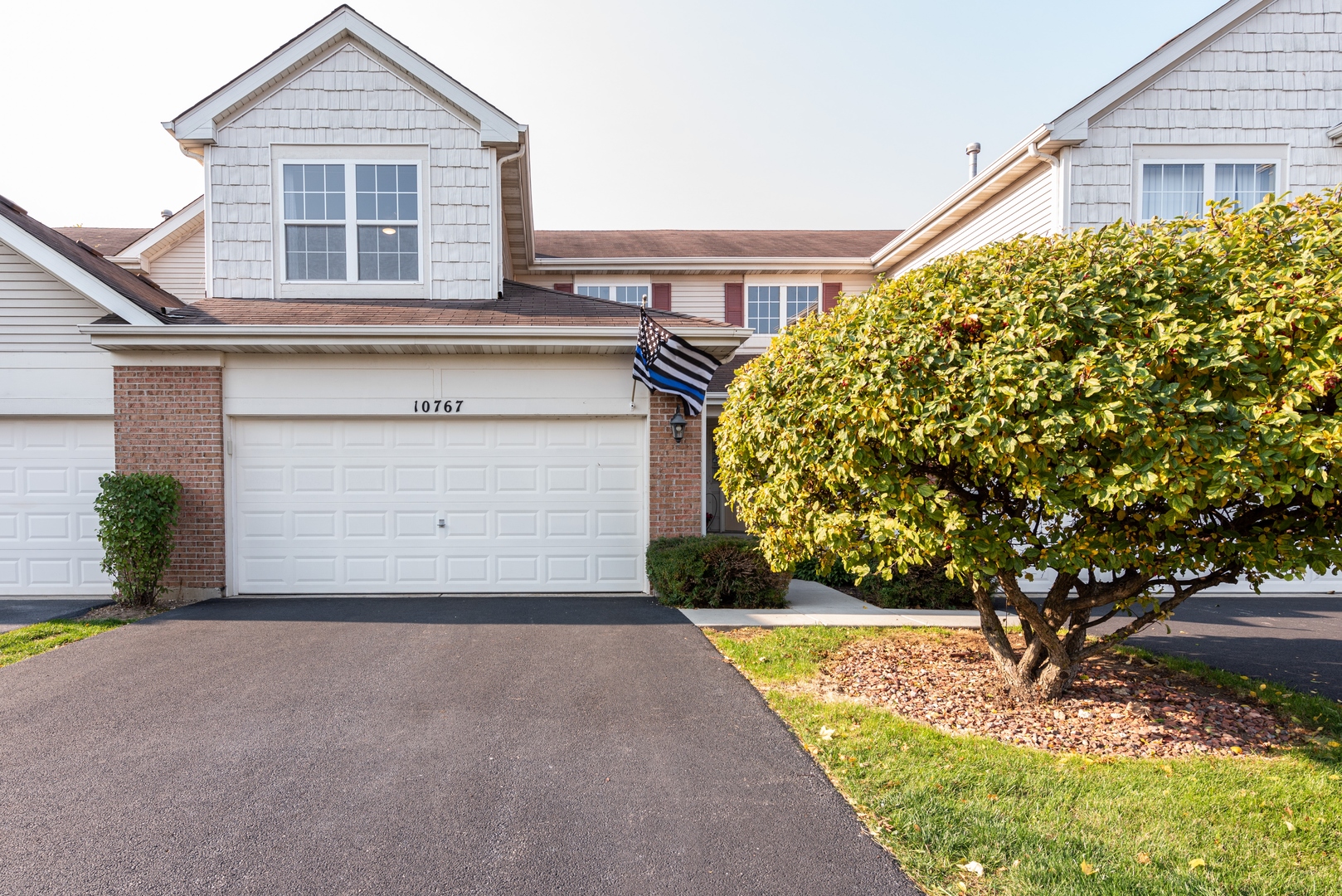 10767 Cape Cod Lane Huntley, IL 60142 - Photo 1 of 14 a front view of a house with a yard and garage