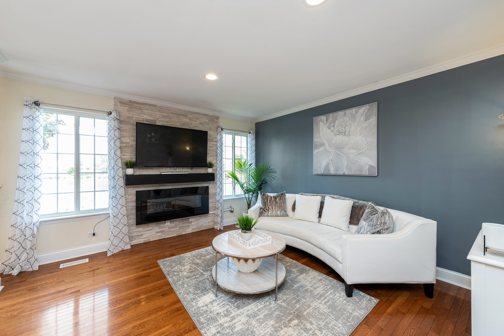 10767 Cape Cod Lane Huntley, IL 60142 - Photo 5 of 14 a living room with furniture and a flat screen tv