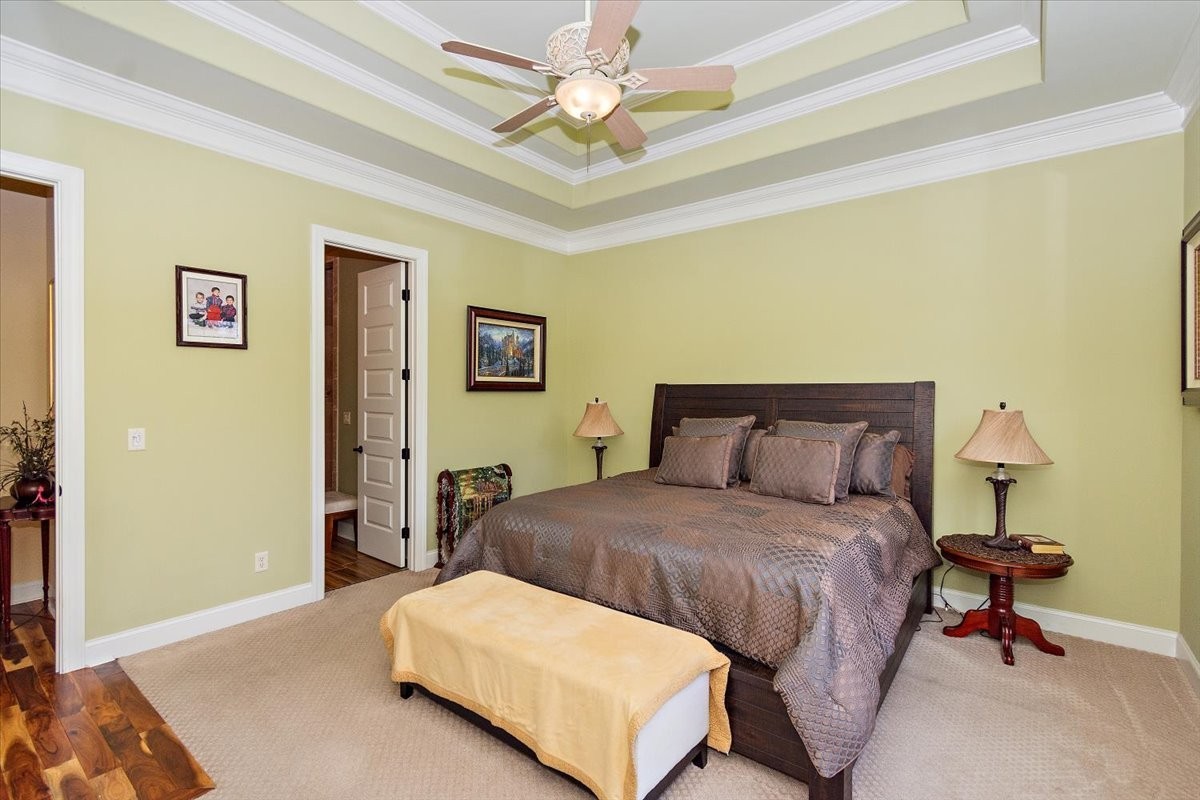 12275 Hogwood Road Milton, TN 37118 - Photo 50 of 89 a bedroom with a bed and a chandelier