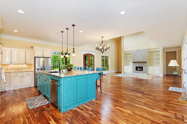 a kitchen with stainless steel appliances granite countertop white cabinets and a stove
