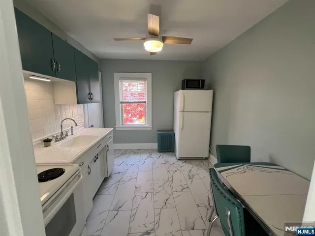 a room with a sink dishwasher and a stove top oven