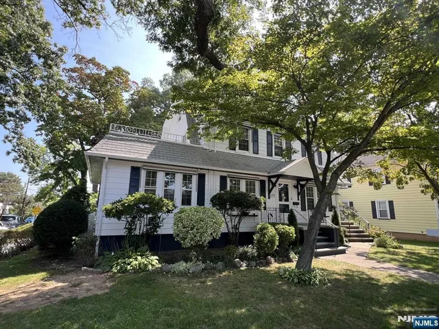 a front view of a house with a yard table and chairs