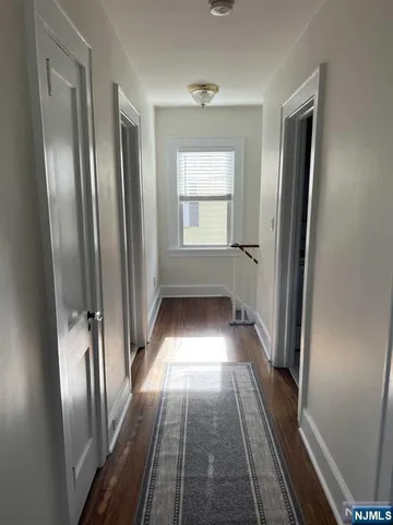 a view of gallery with wooden floor