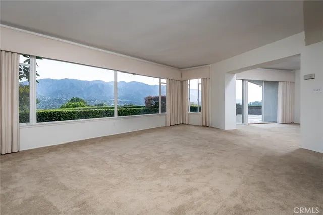 a view of a big room with windows and view of an empty room
