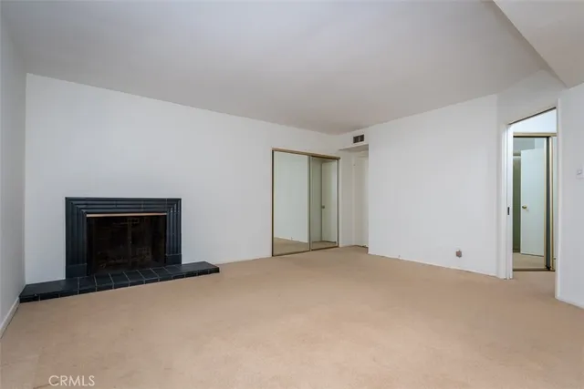 a view of an empty room with a fireplace