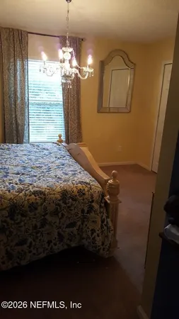 a bedroom with double bunk beds and a mirror