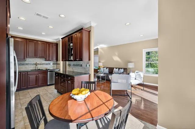 an open kitchen with dining table and chairs
