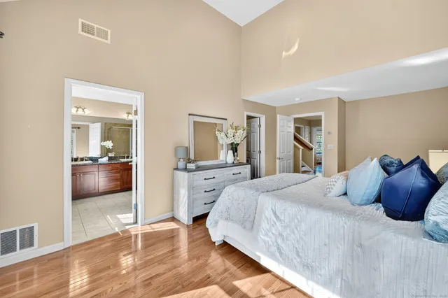 a bedroom with a bed and a view of living room