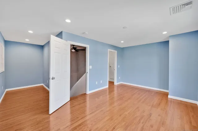 a view of an empty room with wooden floor