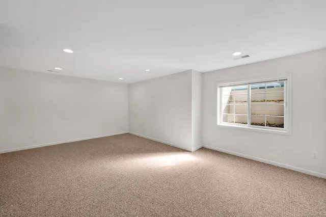 an empty room with a empty space and windows