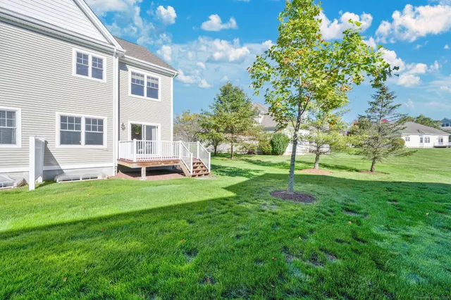 a view of house with a backyard