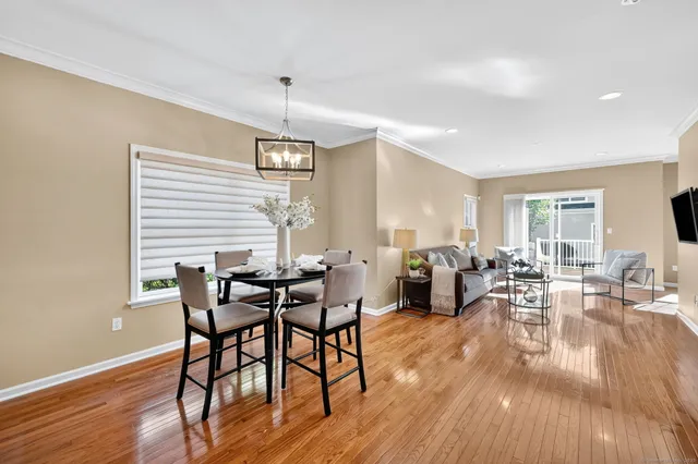 a view of a dining room with furniture window and wooden floor