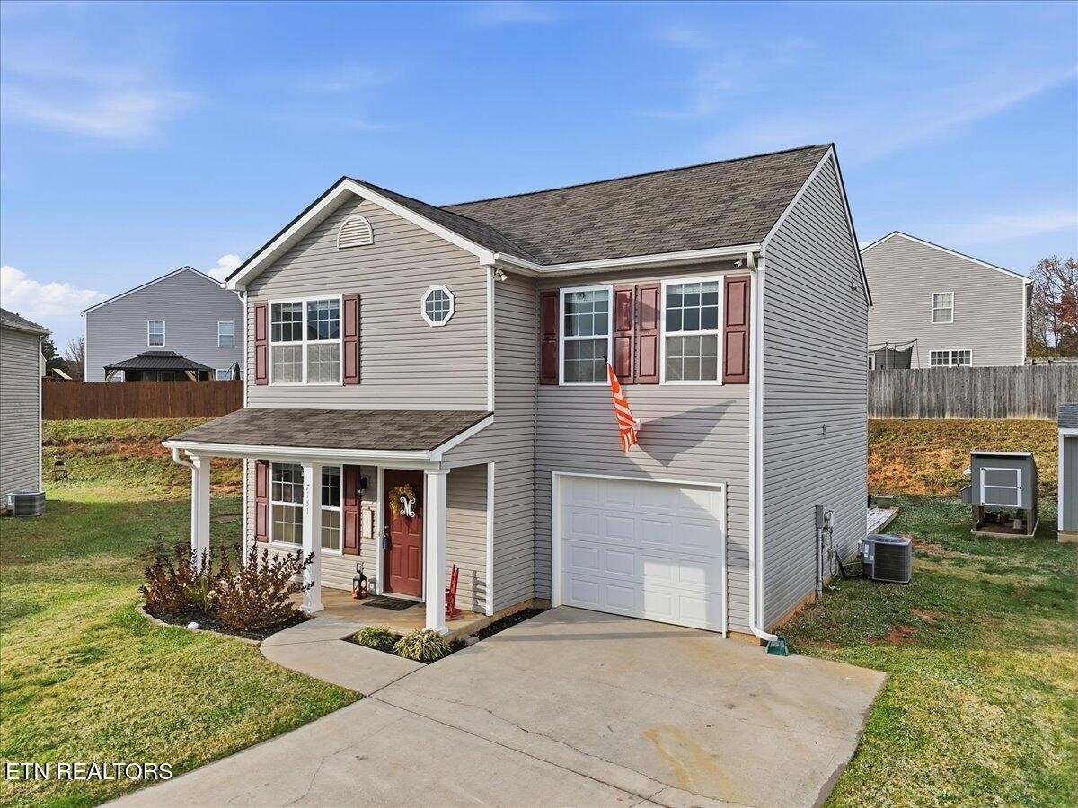 7151 Forest Willow Lane Corryton, TN 37721 - Photo 3 of 24 a front view of a house with garden
