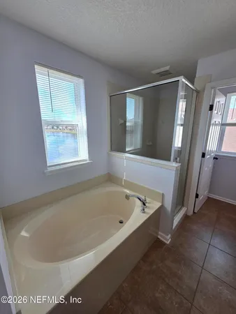 a bath tub sitting in a bathroom next to a window