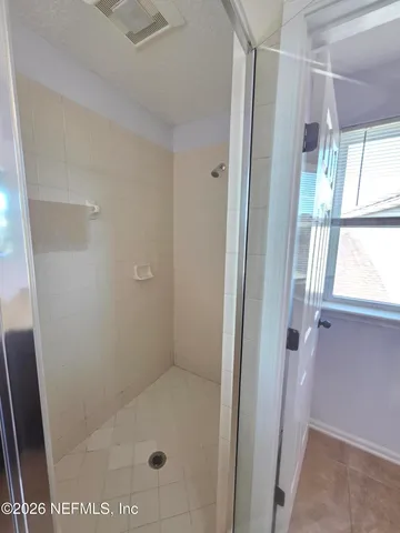 a bathroom with a glass shower door