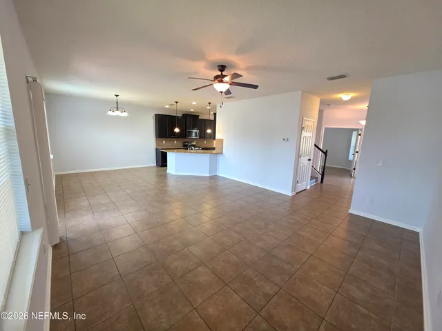a view of a kitchen with a sink and a chandelier fan