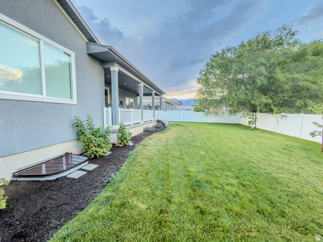 3269 West 650 North Layton, UT 84041 - Photo 30 of 35 Expansive backyard featuring a manicured lawn, a large mature tree, and a white vinyl privacy fence