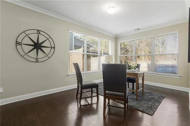 a view of a dining room with furniture window and wooden floor