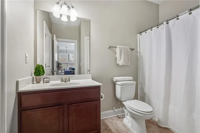 a bathroom with a sink a toilet and mirror