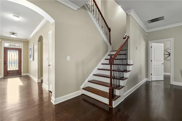 a view of entryway with wooden floor and stairs