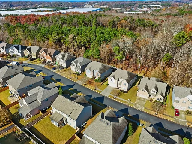 an aerial view of a house with a yard lake view