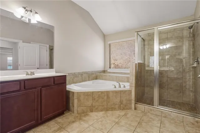 a bathroom with a bathtub sink and mirror