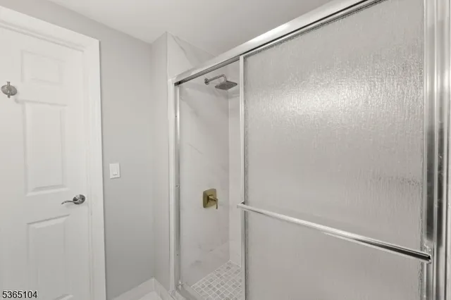 a bathroom with a glass shower door
