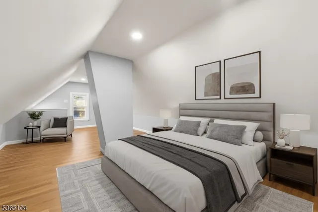 a bedroom with a large bed and painting on the wall