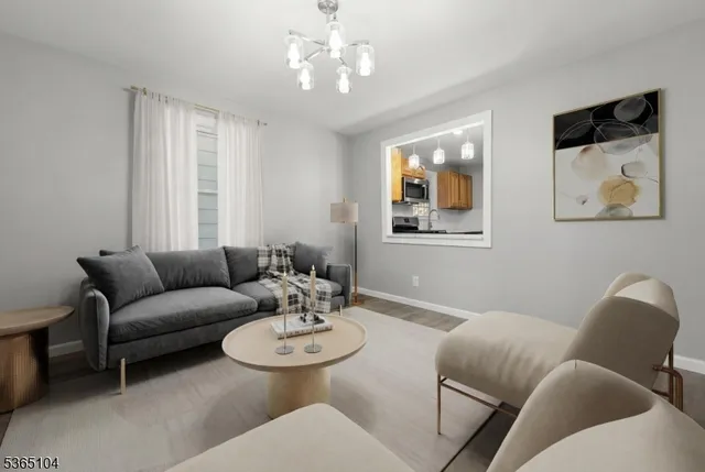 a living room with furniture and a chandelier