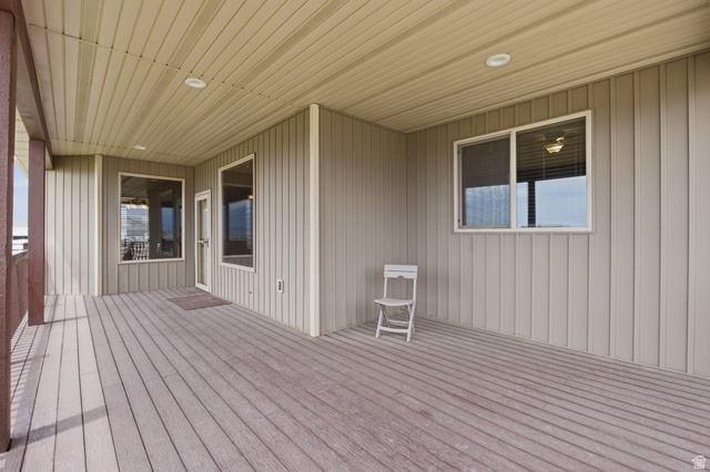 2567 West Rim Rock Drive Stockton, UT 84071 - Photo 44 of 64 Covered outdoor deck with composite decking, recessed lighting, and vertical siding