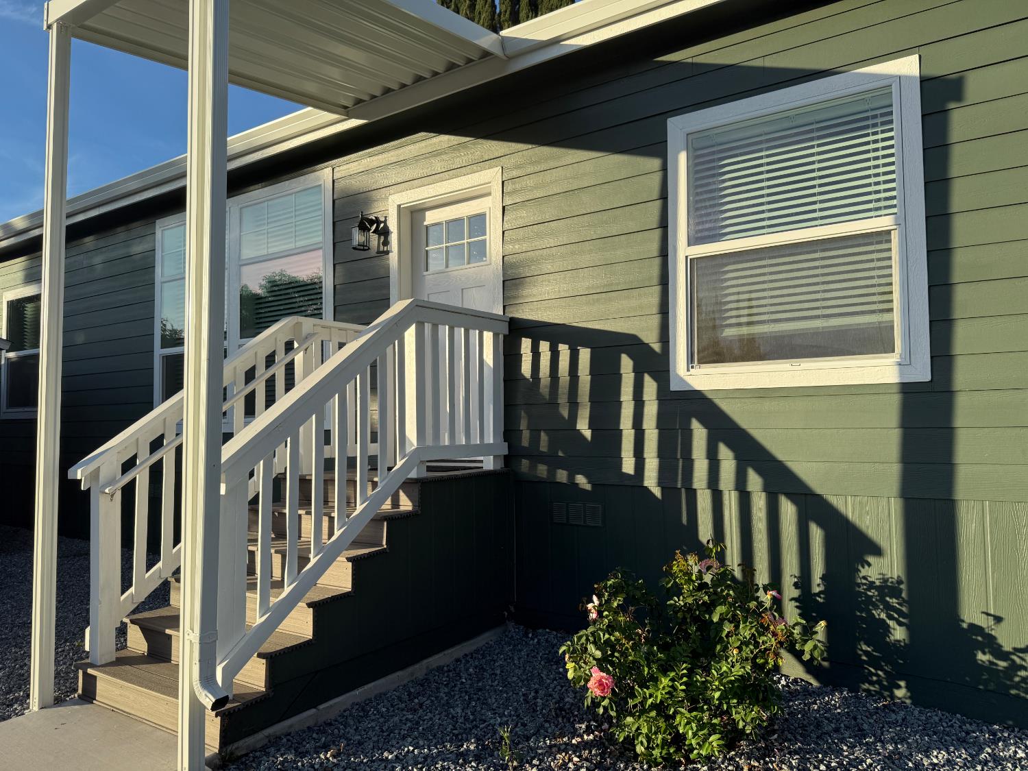 a view of a balcony with flower plants