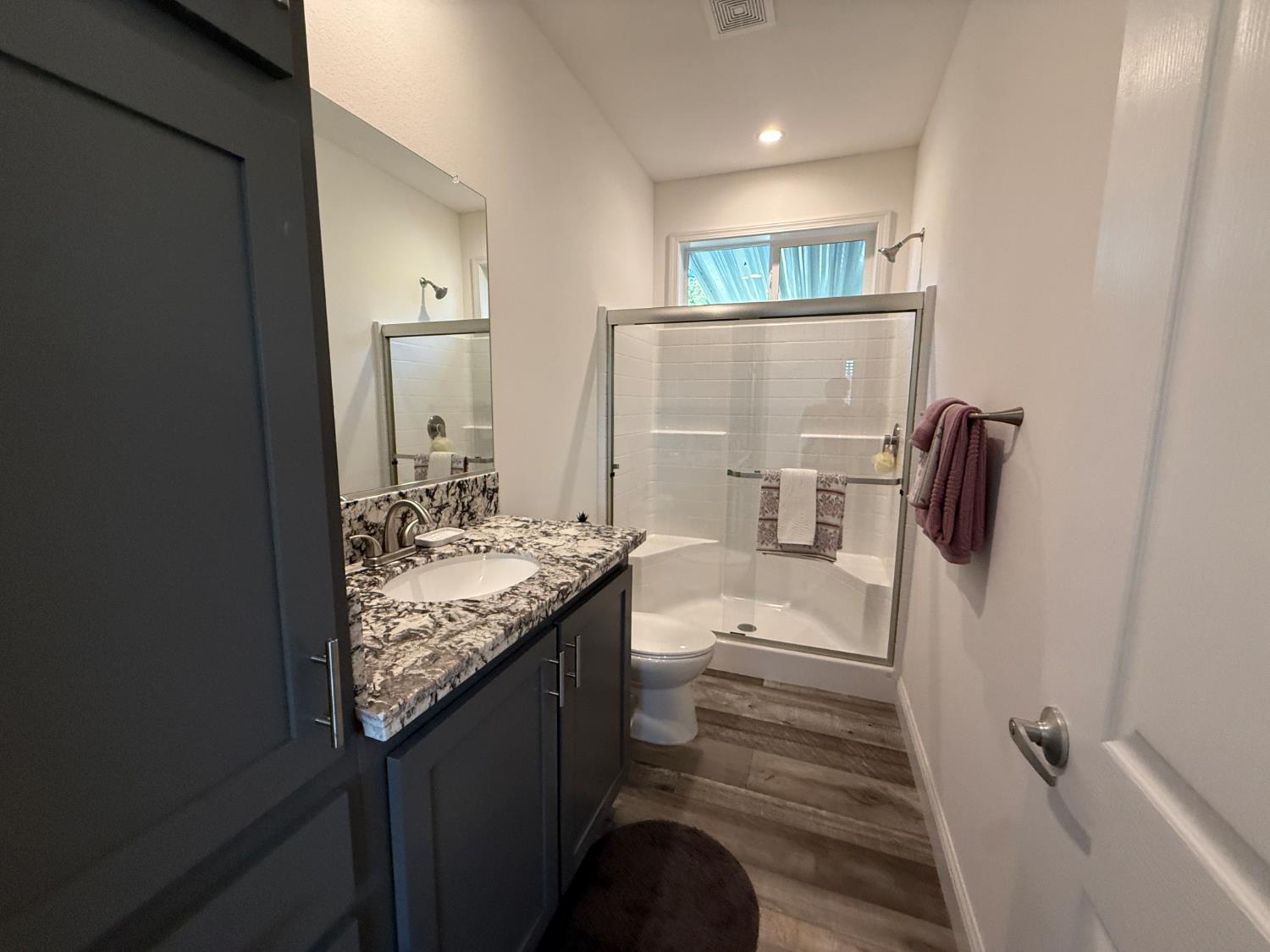 6048 Declaration Circle Citrus Heights, CA 95621 - Photo 13 of 28 a bathroom with a granite countertop sink a toilet and shower