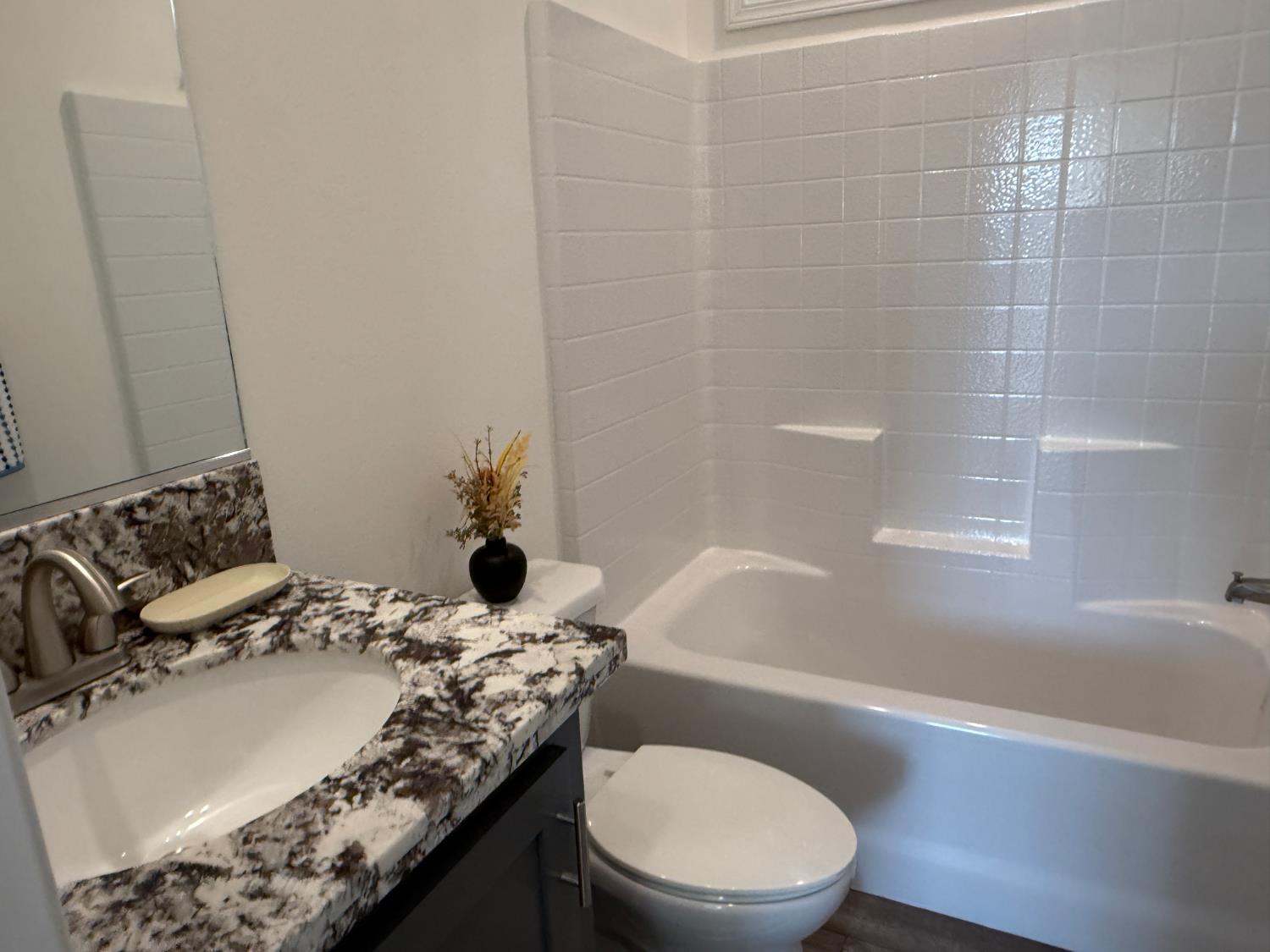 6048 Declaration Circle Citrus Heights, CA 95621 - Photo 8 of 28 a bathroom with a granite countertop sink mirror vanity and toilet