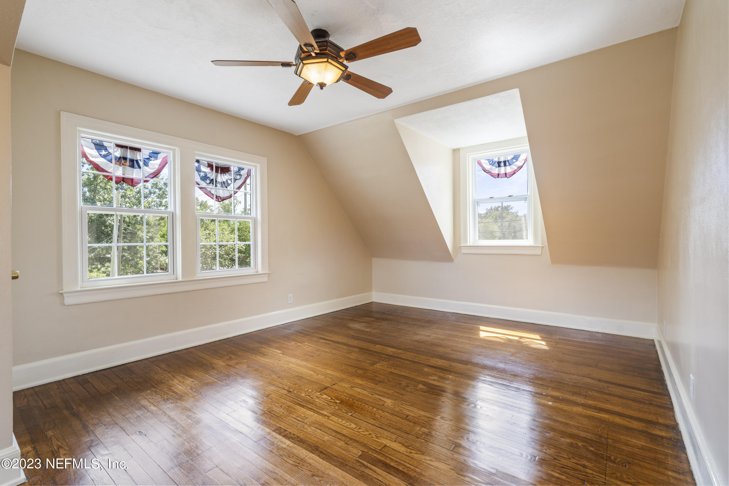 3993 Spring Park Road Jacksonville, FL 32207 - Photo 34 of 41 a view of an empty room with a window and wooden floor