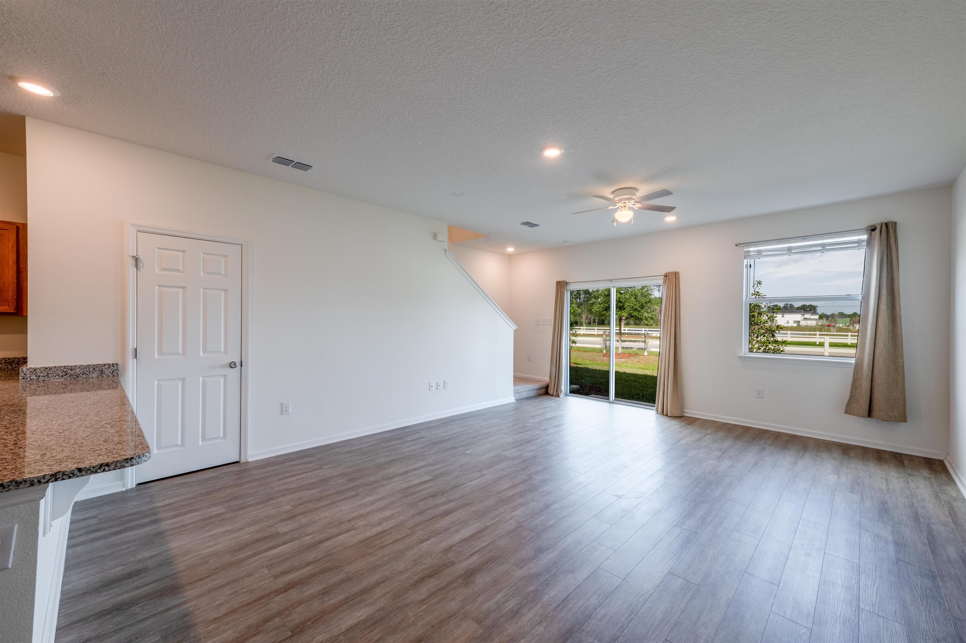 48 Mustard Hill St. Augustine, FL 32086 - Photo 12 of 28 a view of an empty room with wooden floor and a window