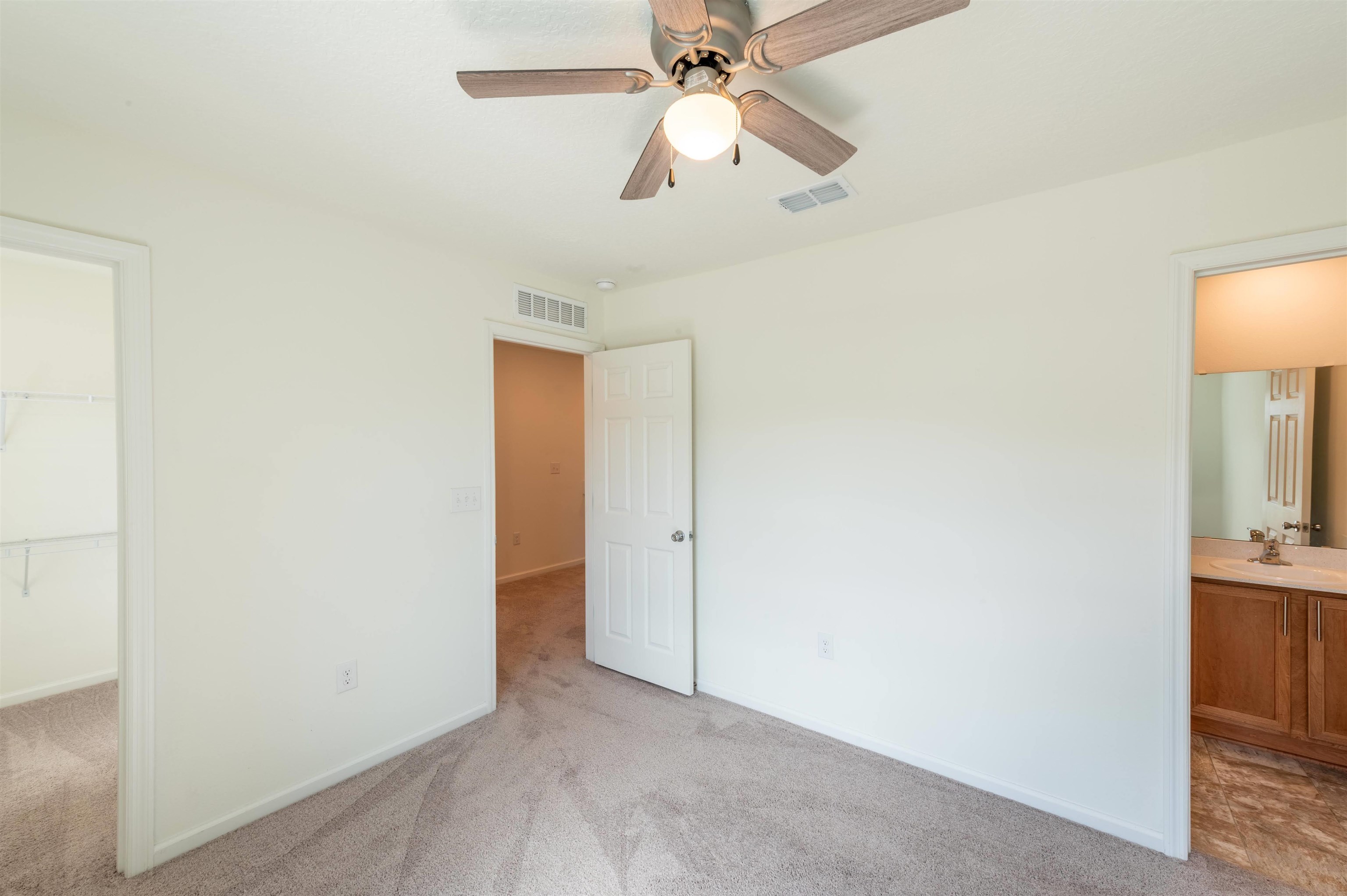 48 Mustard Hill St. Augustine, FL 32086 - Photo 18 of 28 an empty room with closet and a chandelier fan