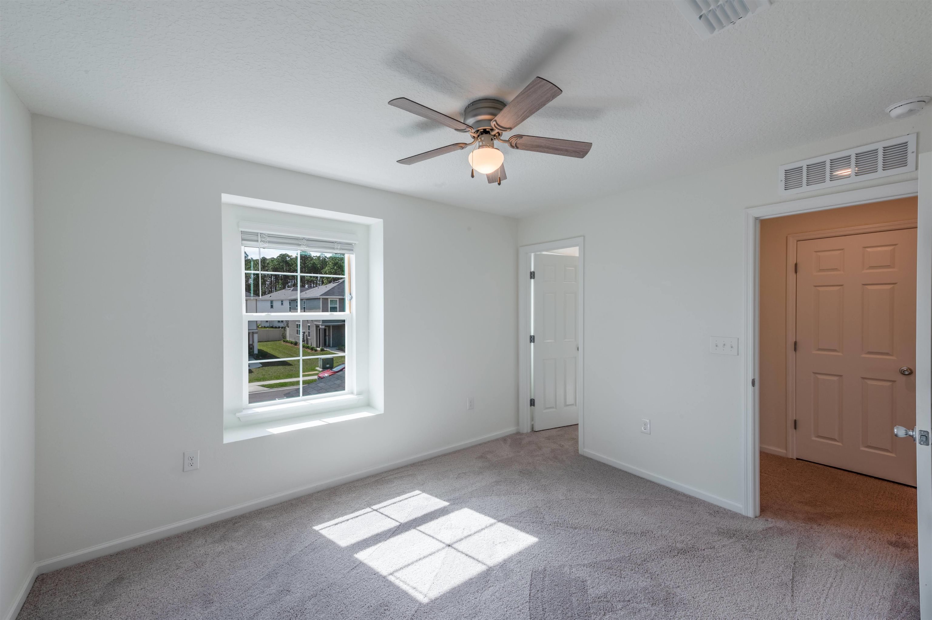 48 Mustard Hill St. Augustine, FL 32086 - Photo 19 of 28 an empty room with windows and fan